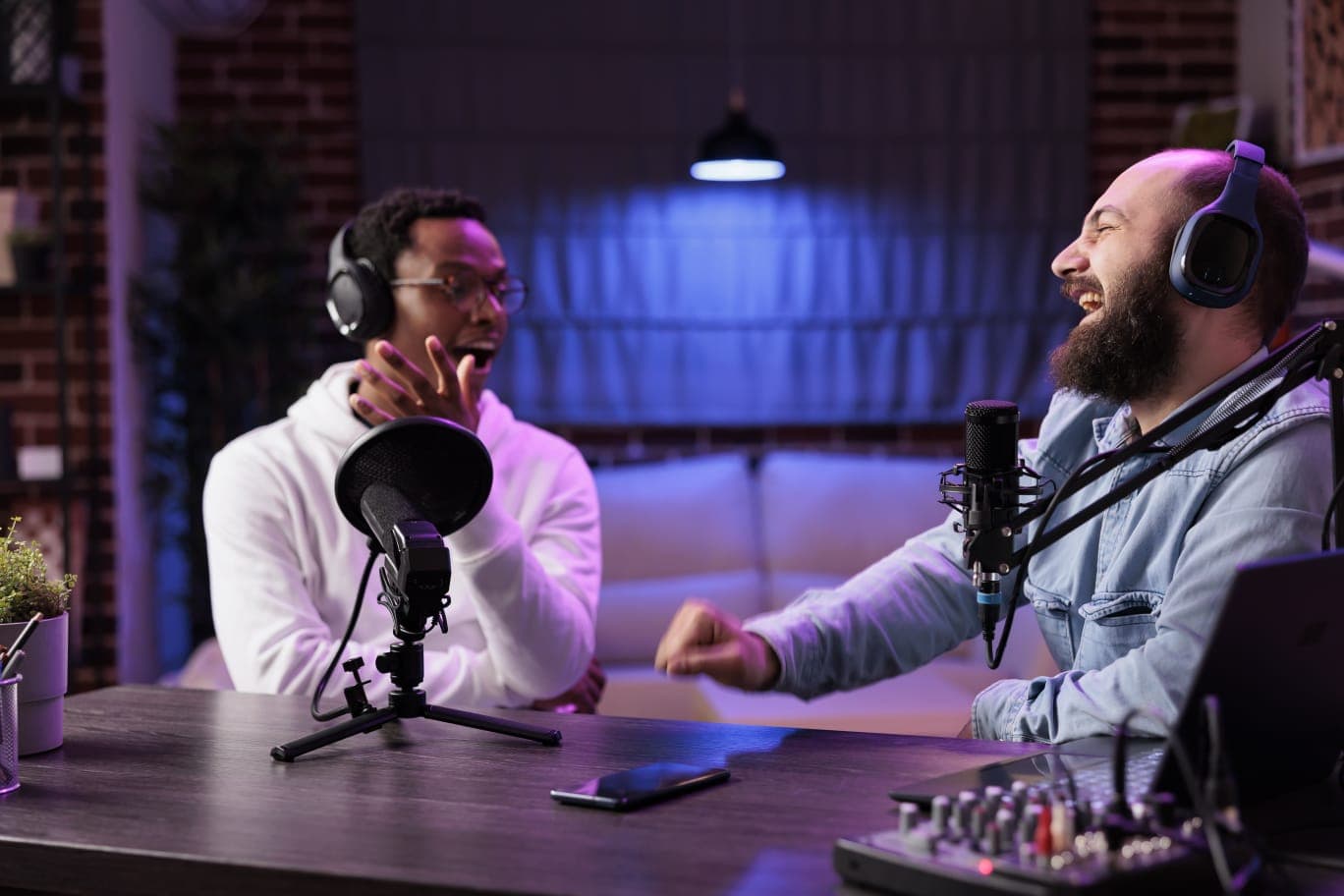 Two people recording the People Suq podcast